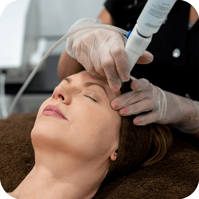 Woman receiving laser treatment for her face