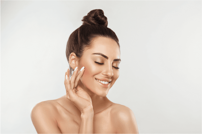 Female touching her face after microdeedling
